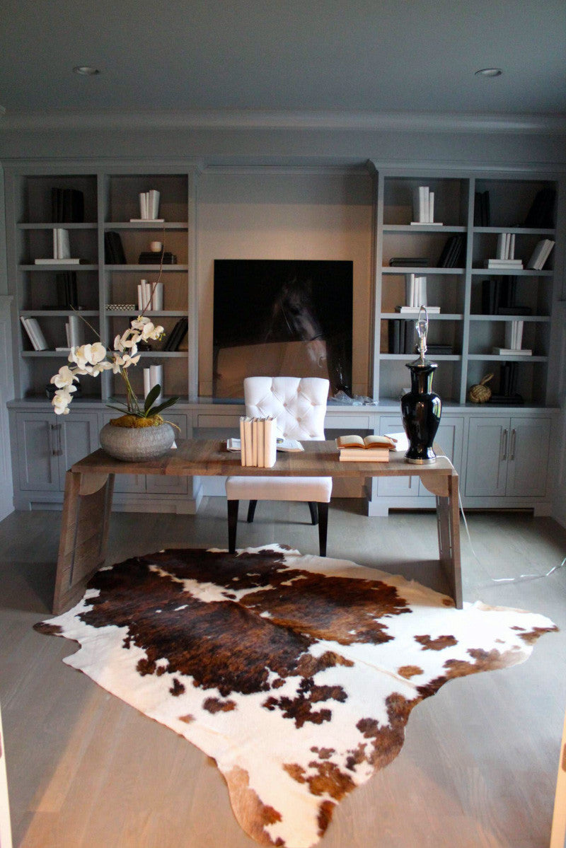 XLarge tri color spotted cowhide rug in room